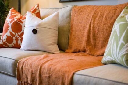 A beatiful sofa with cosy blankets and pillows on it